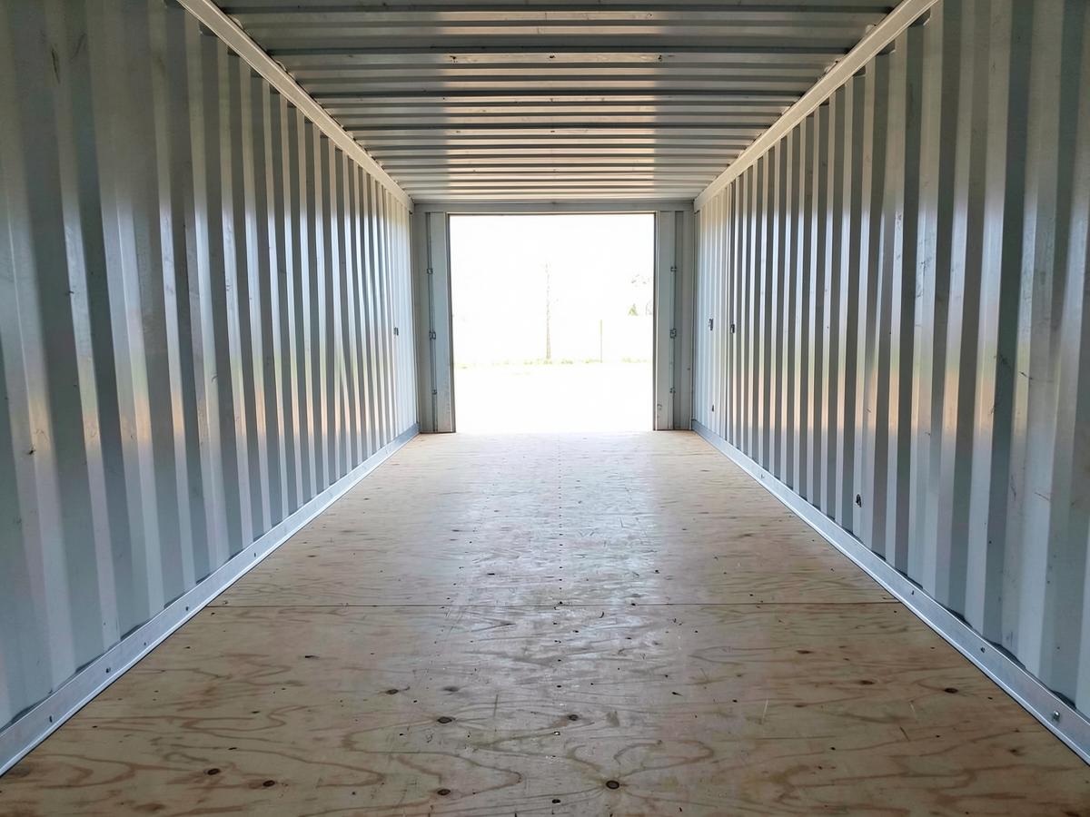 Clean interior of a 20ft shipping container with plywood floor